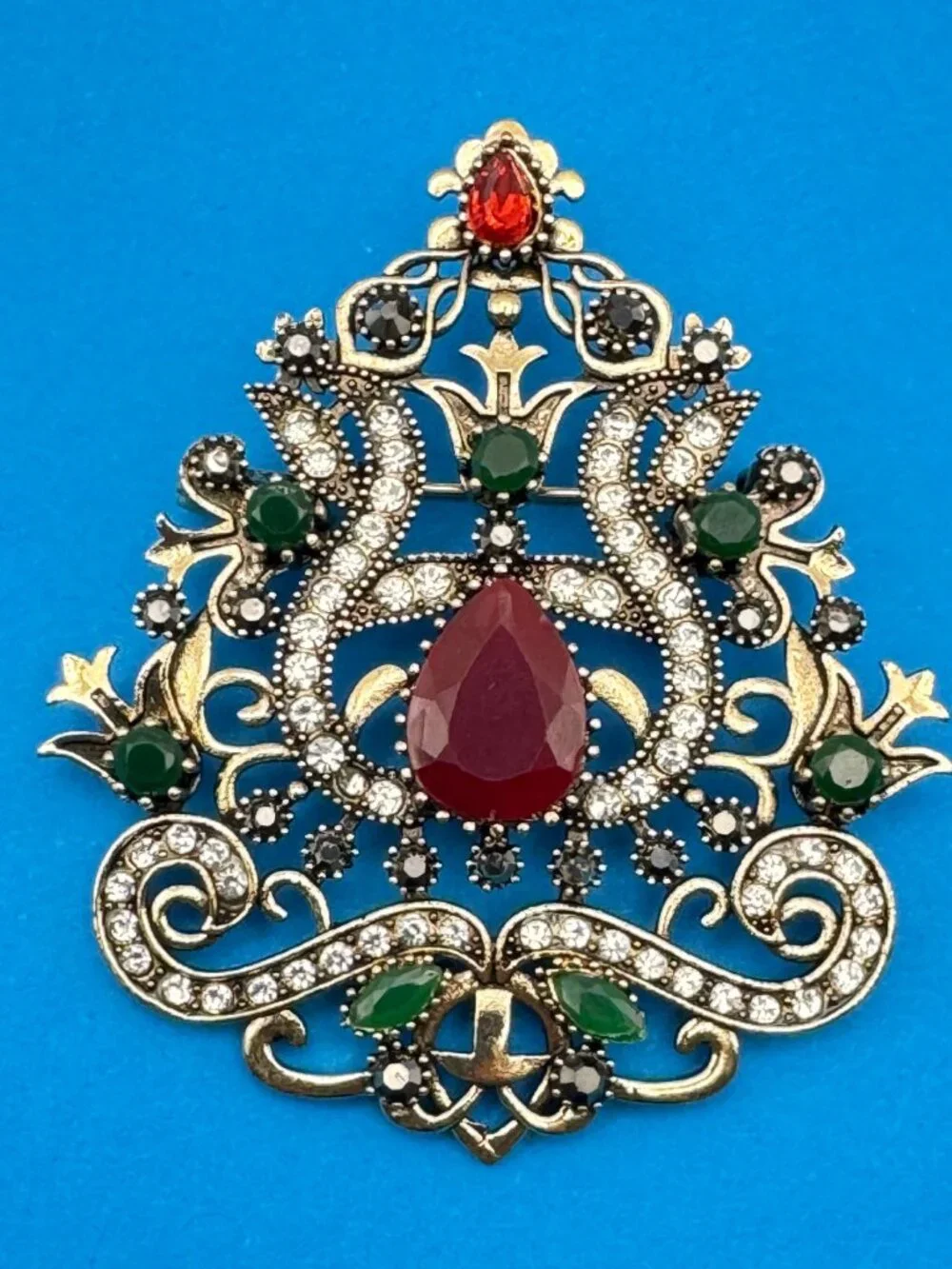 Ornate Shield Brooch Pin Red Green Clear Rhinestones Gold Tone Filigree